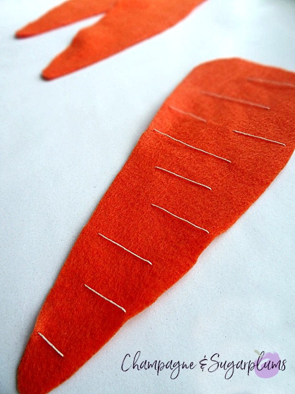 Completed felt carrot on a white background by Champagne and Sugarplums