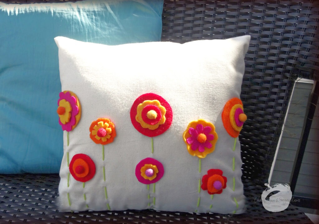 Finished DIY Pillow Cover outside on a bench by Champagne and Sugarplums