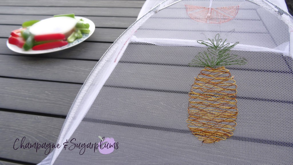 A summer food tent with embroidered fruits on a picnic table by Champagne and Sugarplums