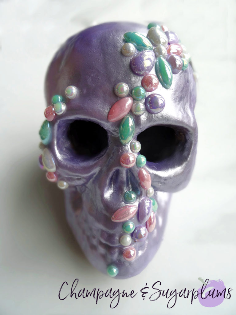Completed jeweled skull on a white background by Champagne and Sugarplums 
