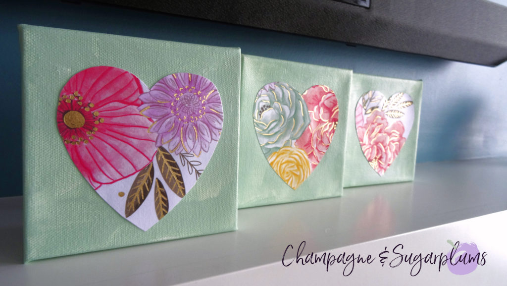 Three completed floral triptych canvases with paper hearts by Champagne and Sugarplums