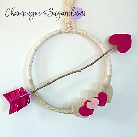Valentine's Day Wreath hanging on a white background by Champagne and Sugarplums