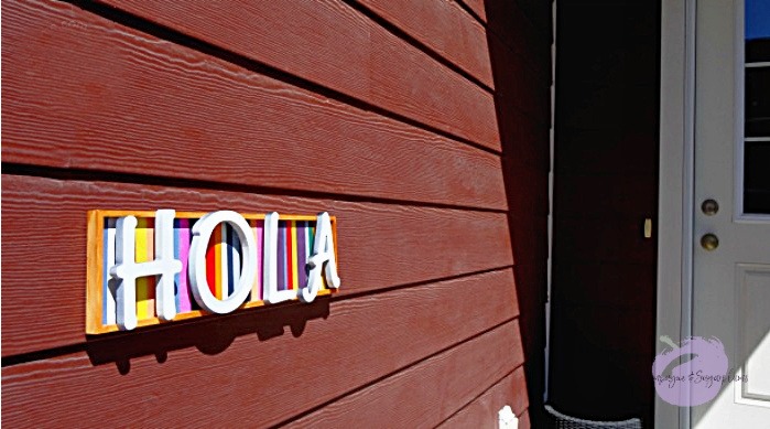 Finished welcome sign hanging beside a front door  by Champagne and Sugarplums