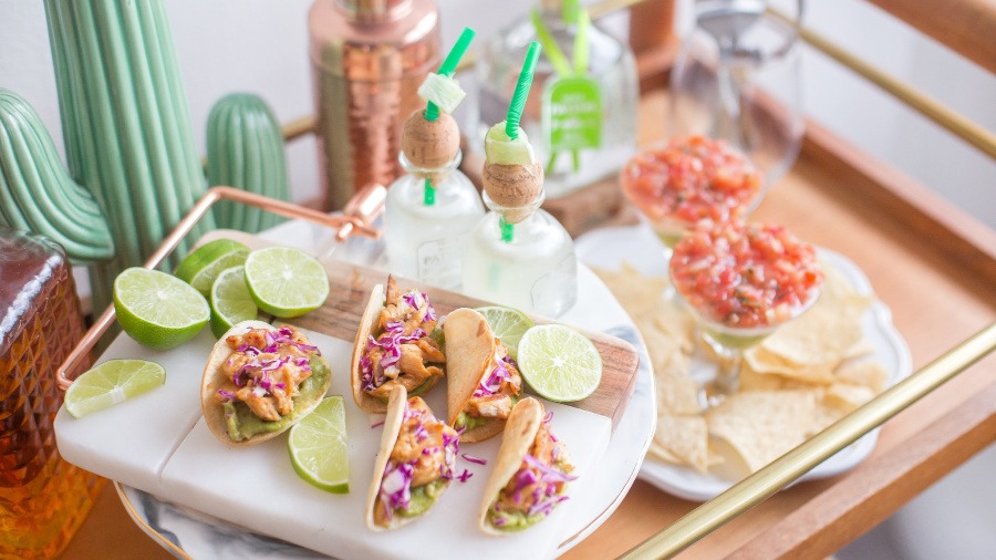 Festive tray of taco and margaritas with limes and a cactus by Champagne and Sugarplums