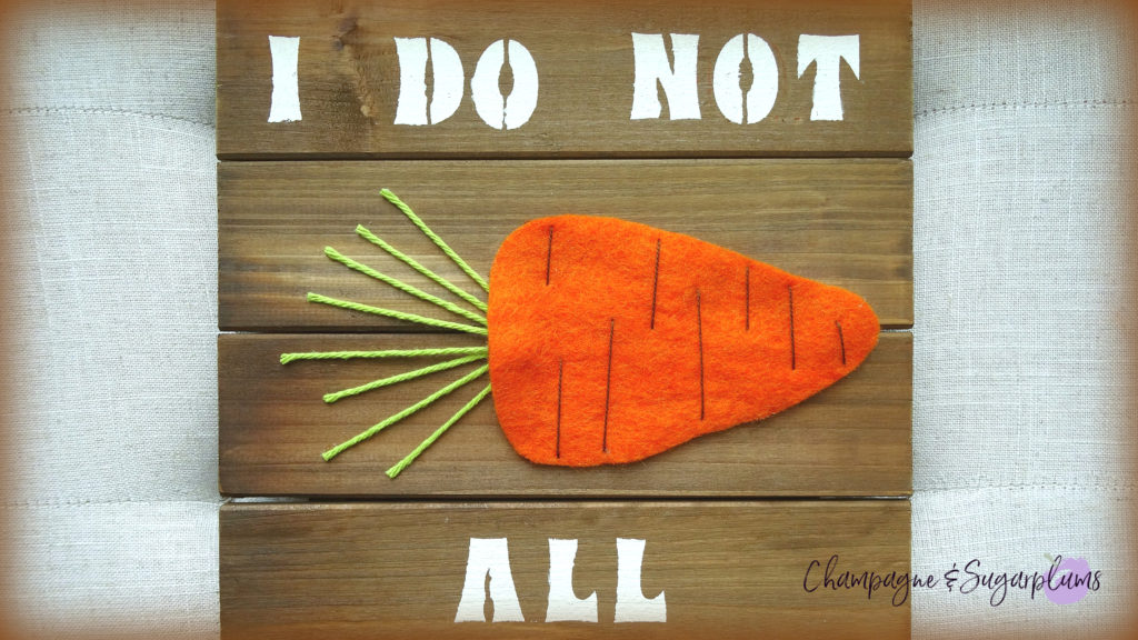 Easter sign text 'I Do Not' and 'All' with a felt carrot in the middle by Champagne and Sugarplums