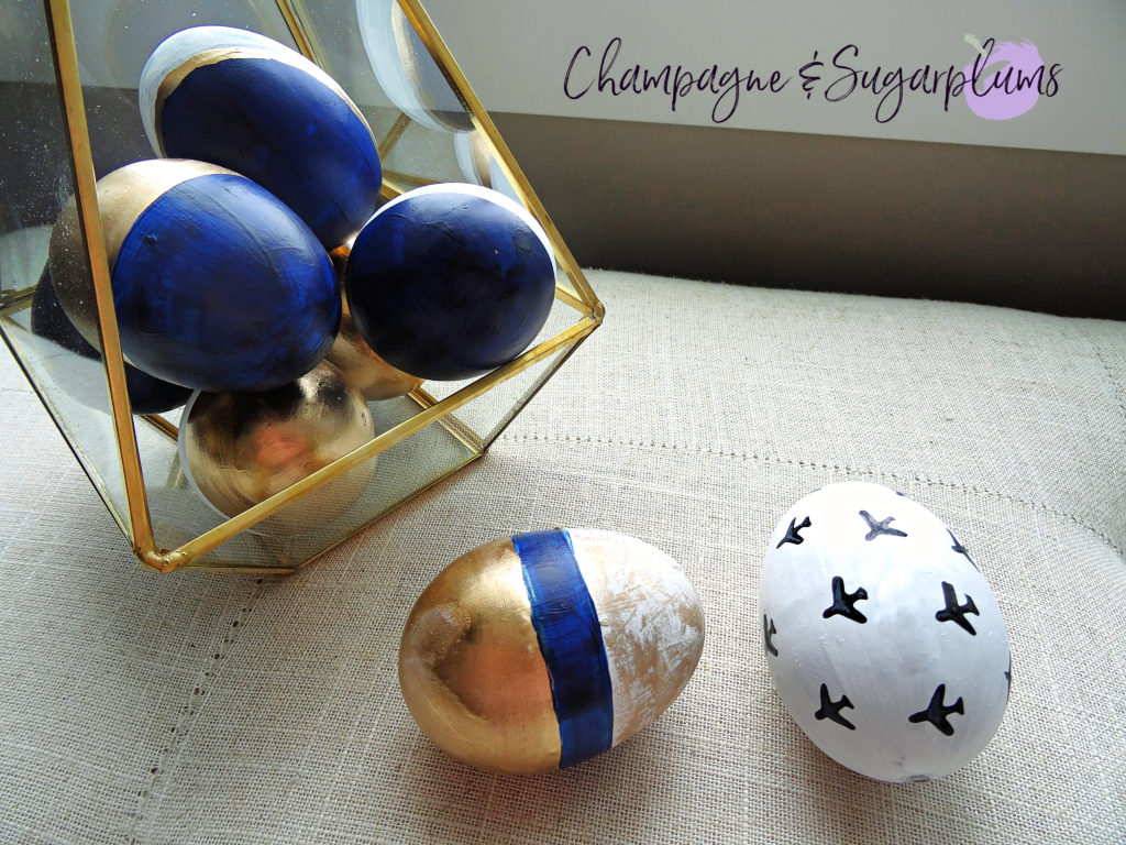 Gold and blue patterned Easter eggs in terrarium and on a bench by Champagne and Sugarplums