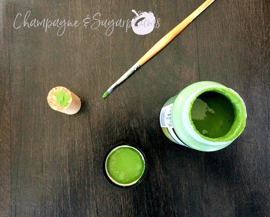 Top of a cork being painted green by Champagne and Sugarplums