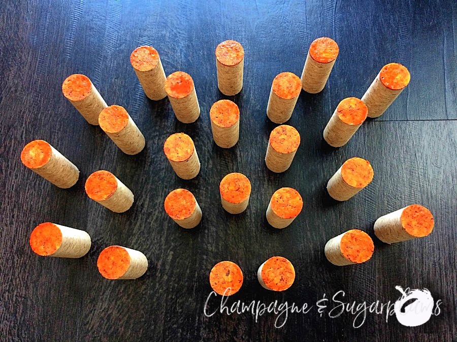 Corks with the tops painted orange by Champagne and Sugarplums