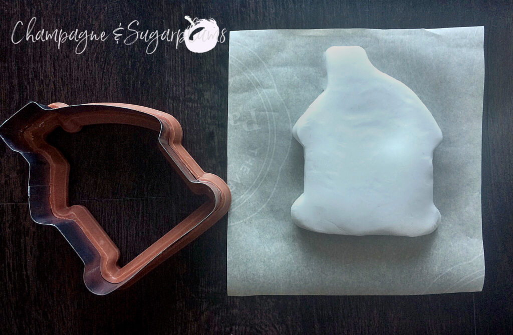 Cutting clay with a gingerbread shaped cookie cutter by Champagne and Sugarplums