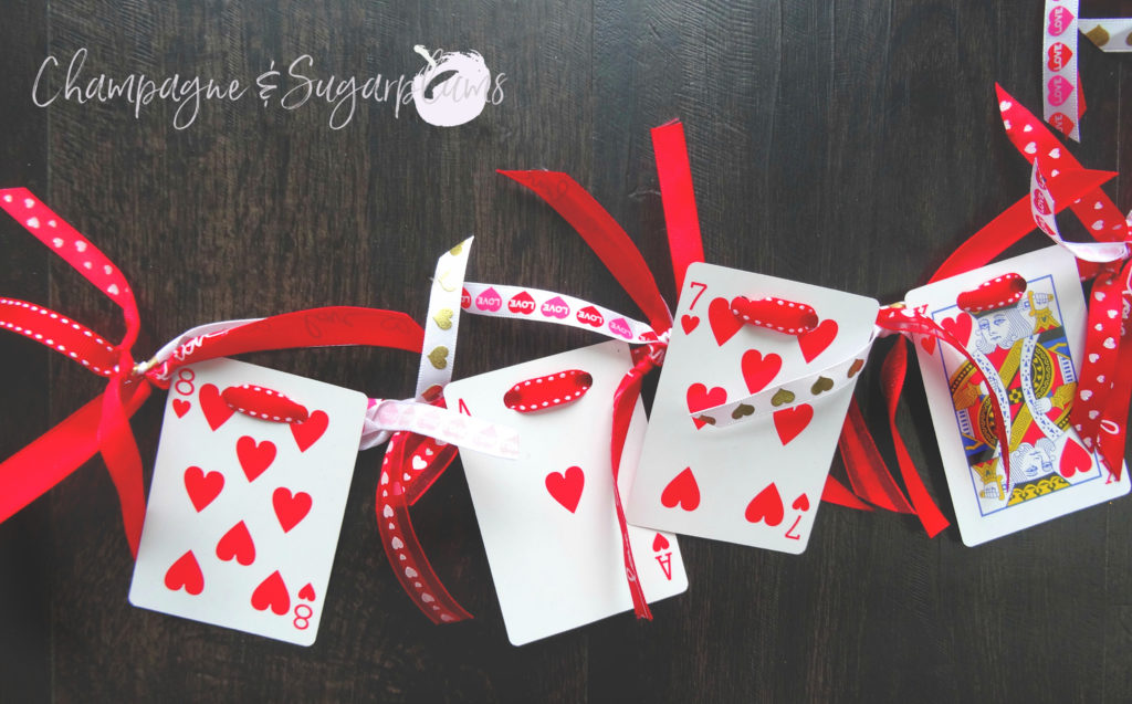 Heart cards garland on a dark background by Champagne and Sugarplums