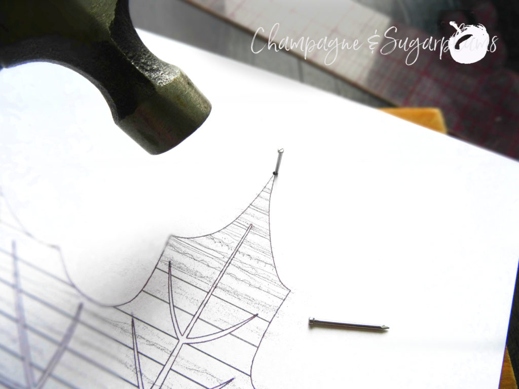 Paper leaf template nailed to a wood board by Champagne and Sugarplums