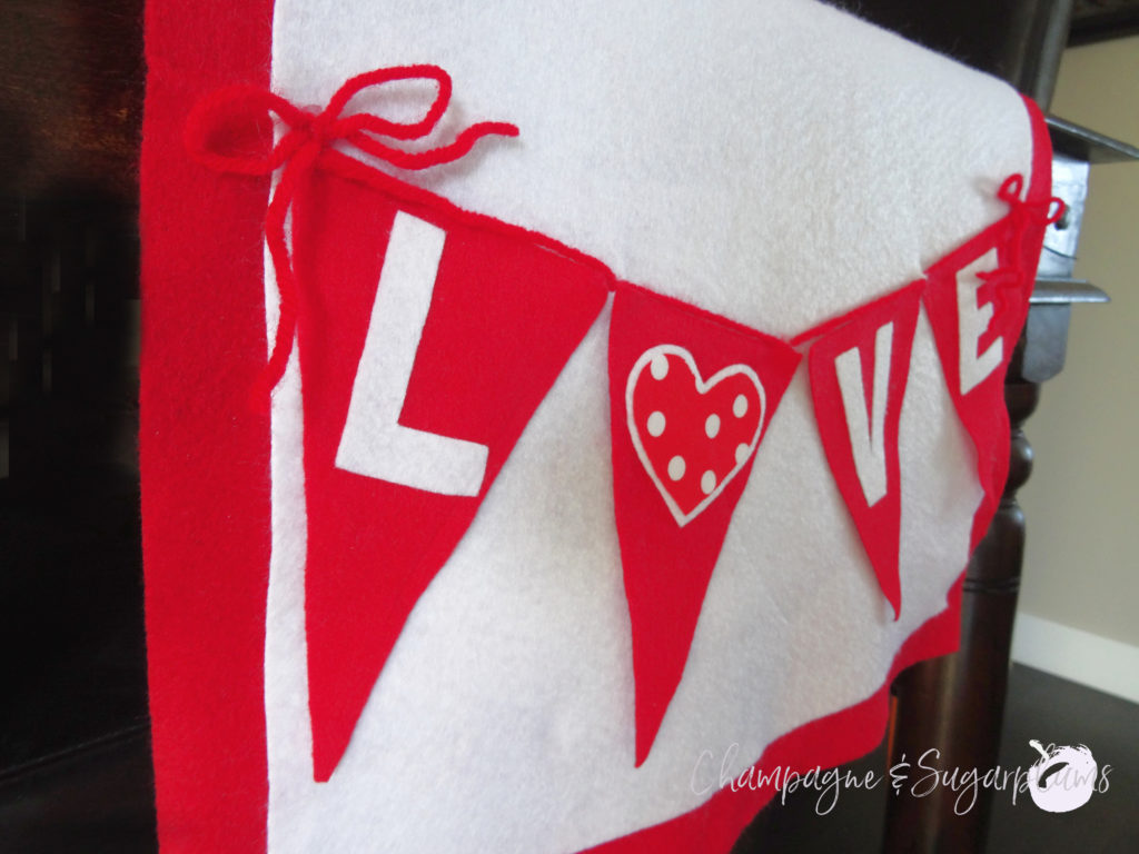 Love table runner on a dark table, close-up on an angle by Champagne and Sugarplums