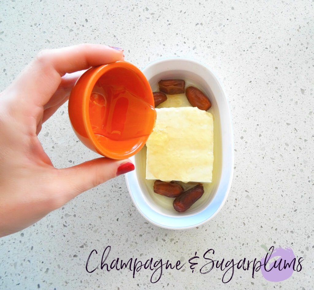 Adding honey to an appetizer by Champagne and Sugarplums