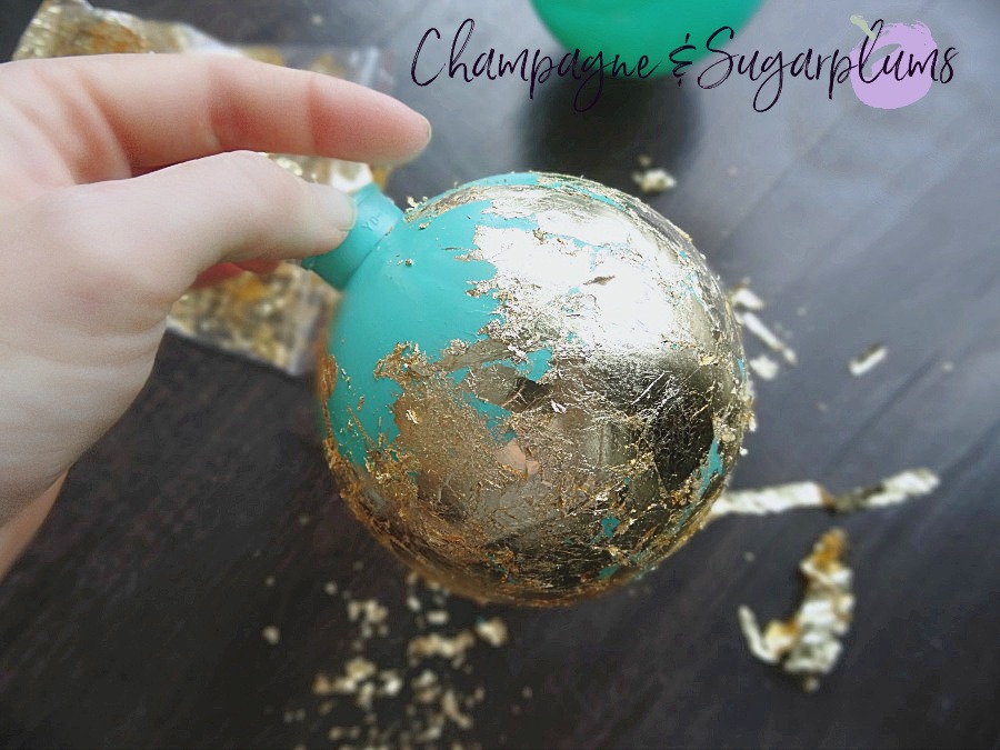 Gold gliding applied to teal ornament by Champagne and Sugarplums