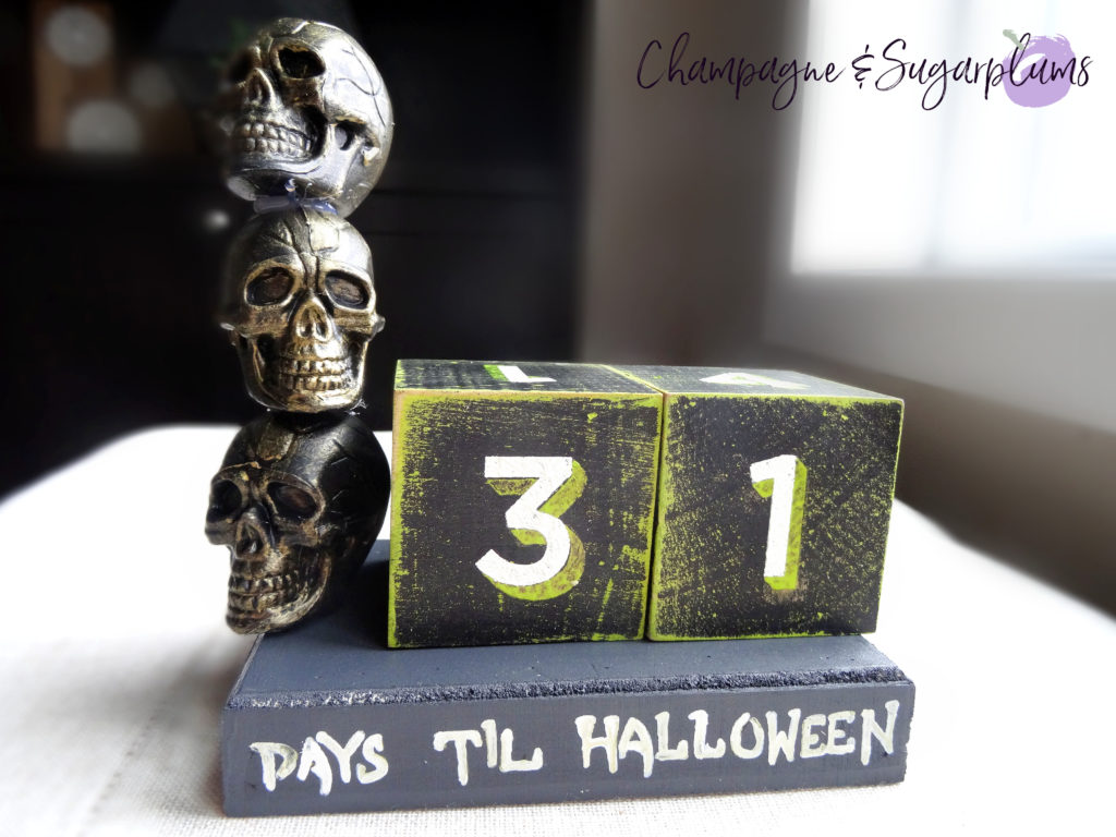 Halloween advent skull advent on a bench in front of a window by Champagne and Sugarplums