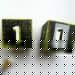 Two wooden blacks painted in black and green with the number one on them by Champagne and Sugarplums
