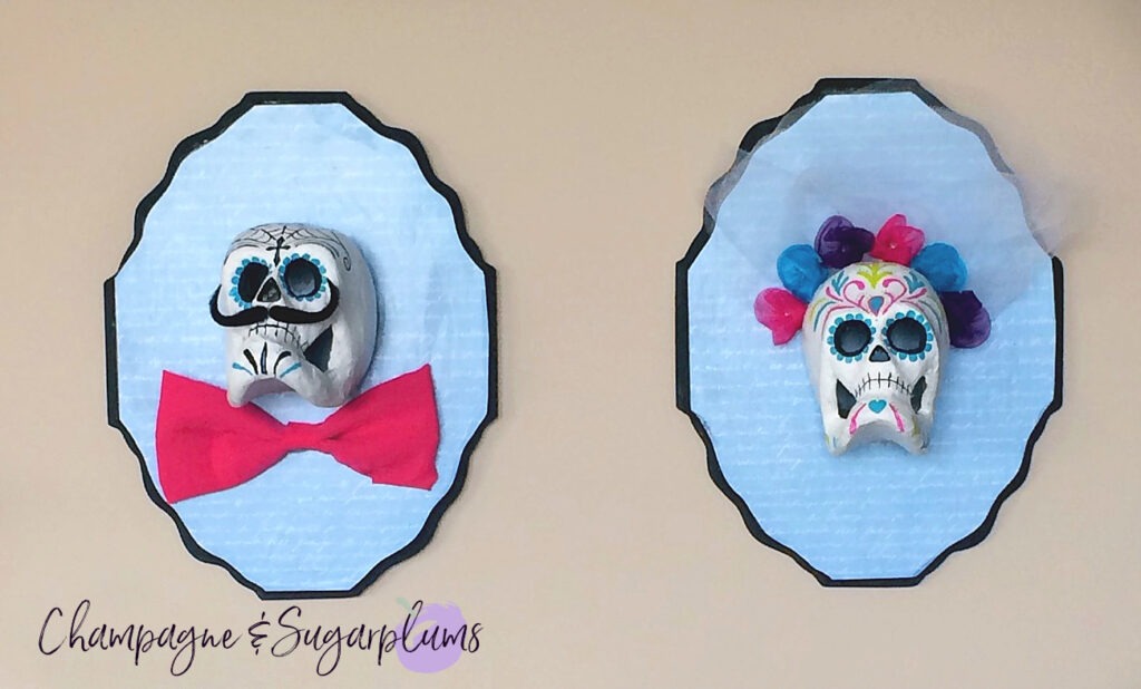 Sugar skulls hanging on a wall by Champagne and Sugarplums