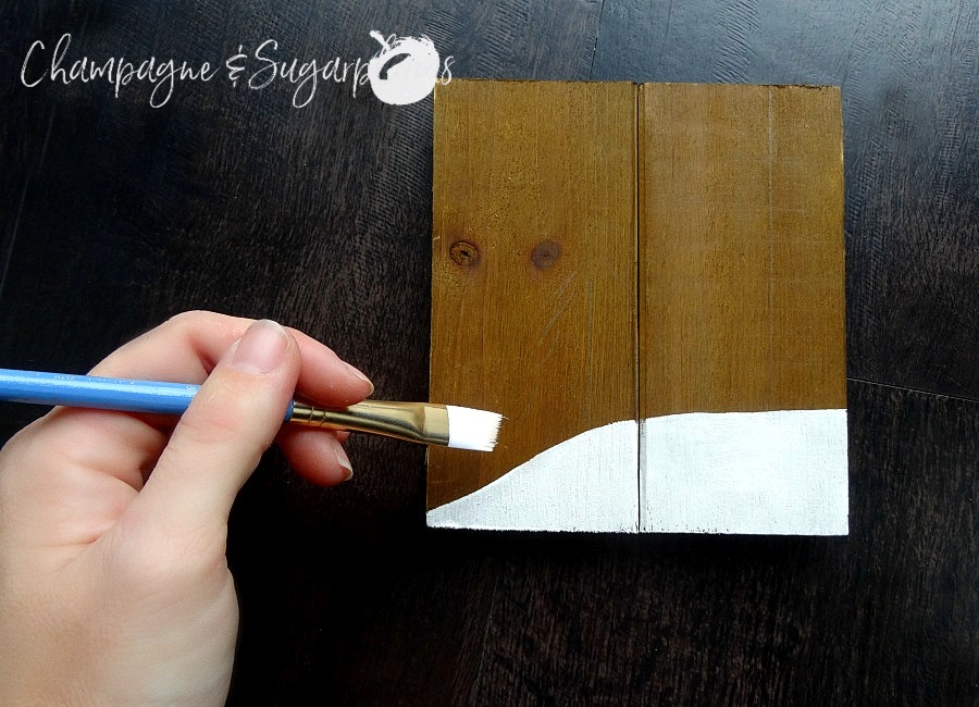 Painting a snow bank onto a wood plank by Champagne and Sugarplums