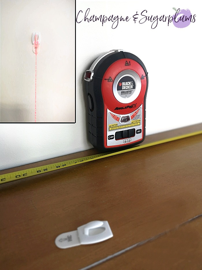 Laser level on a table with a measuring tape by Champagne and Sugarplums