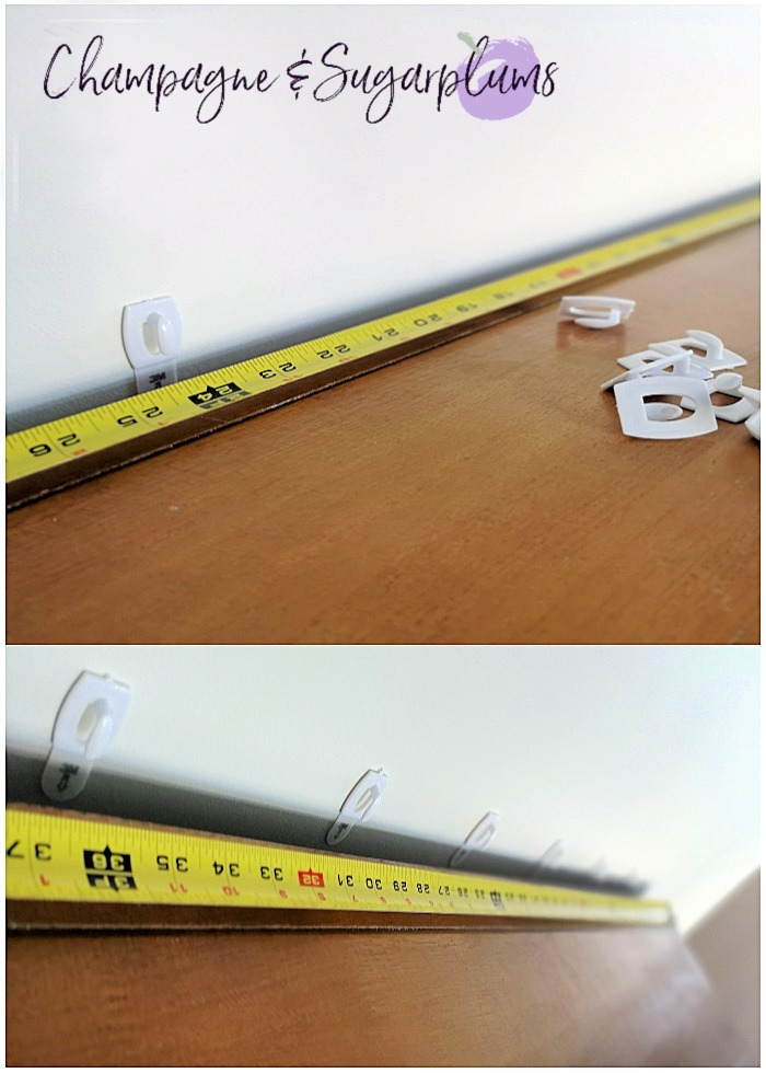 Measuring tape on a table with mini commend hooks by Champagne and Sugarplums