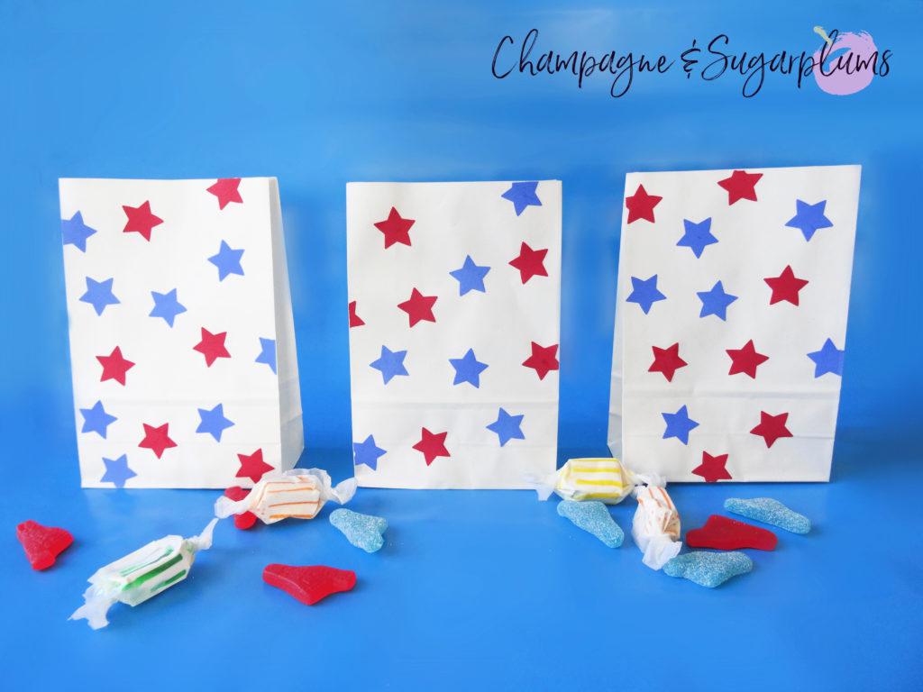 Fourth of July treat bags on a blue background by Champagne and Sugarplums