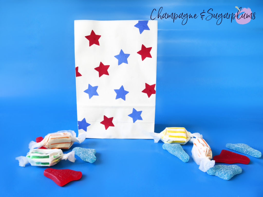 Fourth of July treat bags on a blue background by Champagne and Sugarplums