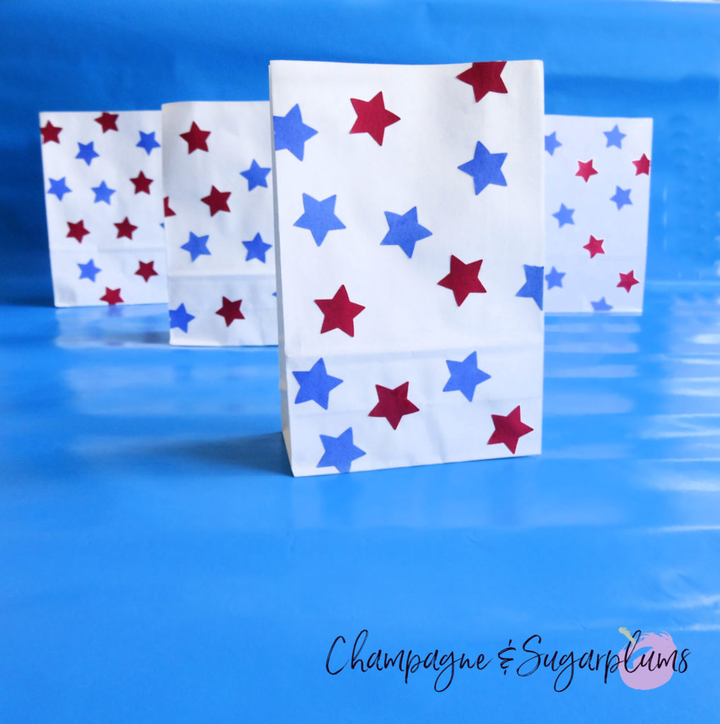 Fourth of July treat bags on a blue background by Champagne and Sugarplums