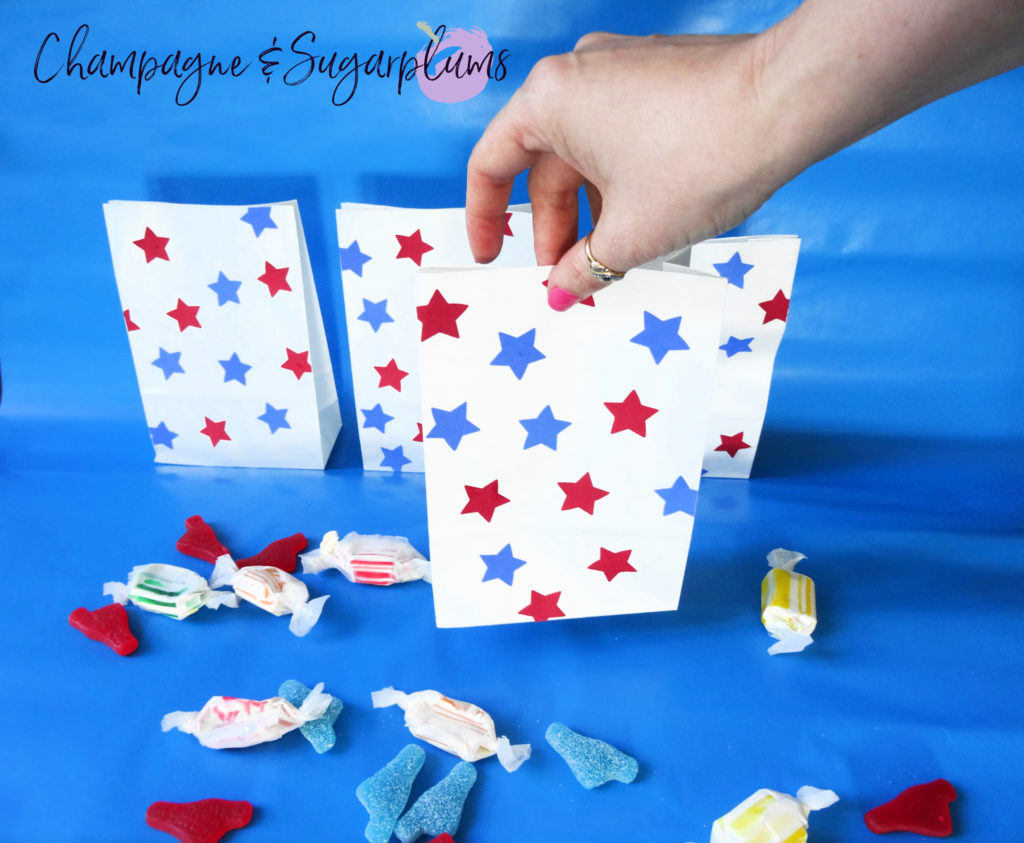 Fourth of July treat bags on a blue background by Champagne and Sugarplums