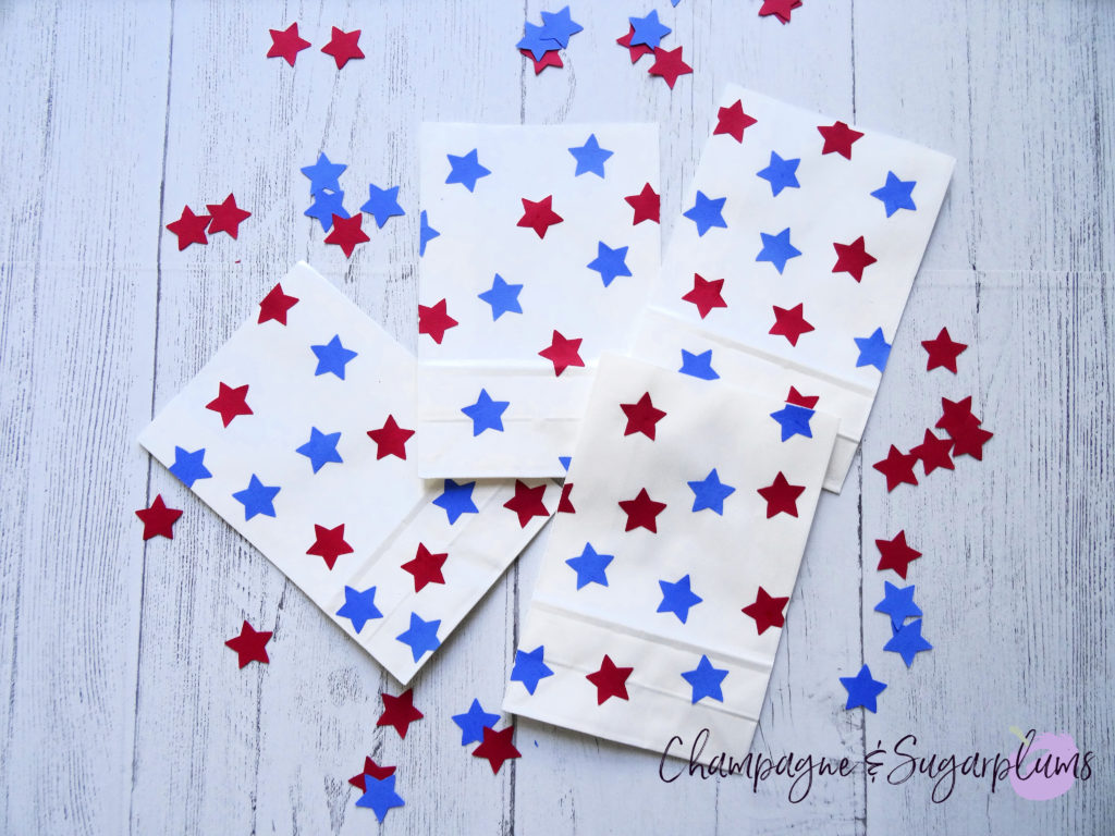 Red and blue stars on paper bags by Champagne and Sugarplums