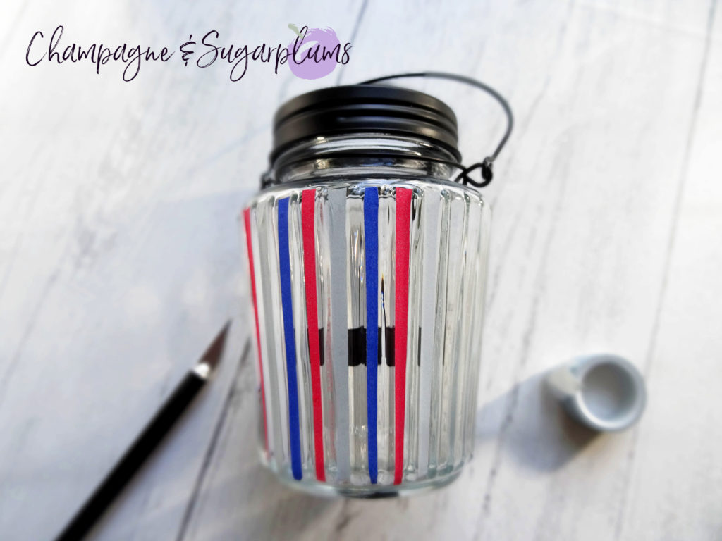 Adding white tape to a glass candle jar by Champagne and Sugarplums