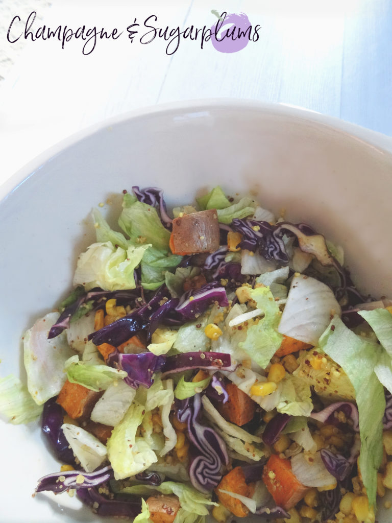 Quinoa Salad with red cabbage and sweet potatoes in a white bowl by Champagne and Sugarplums