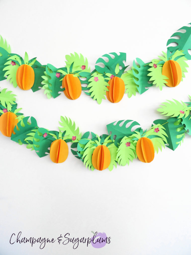 Tropical party decor garland on a white wall by Champagne and Sugarplums