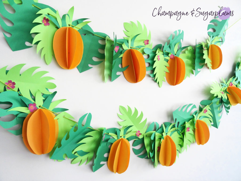 Tropical party decor garland on a white wall by Champagne and Sugarplums