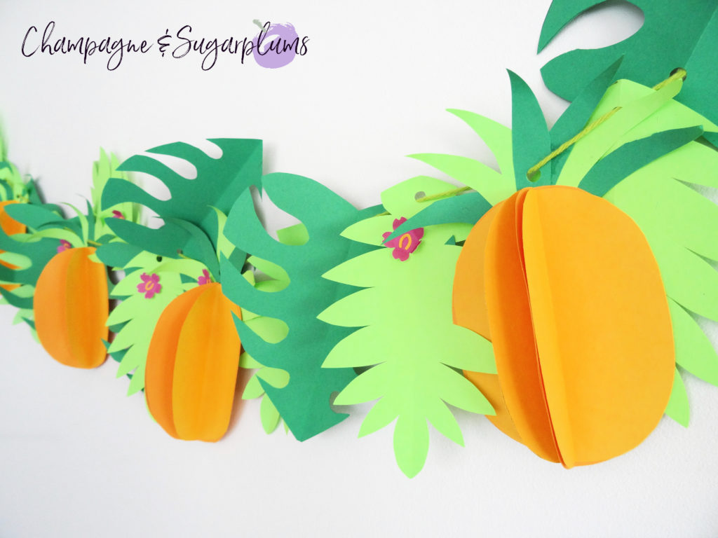 Tropical party decor garland on a white wall by Champagne and Sugarplums