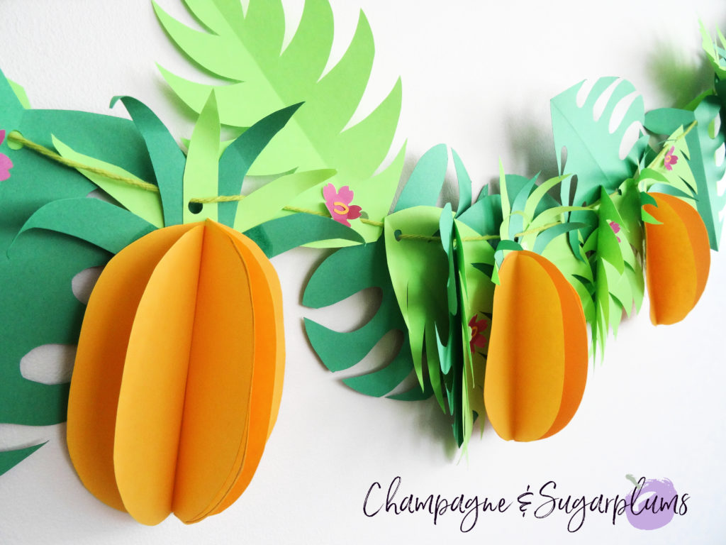 Tropical party decor garland on a white wall by Champagne and Sugarplums