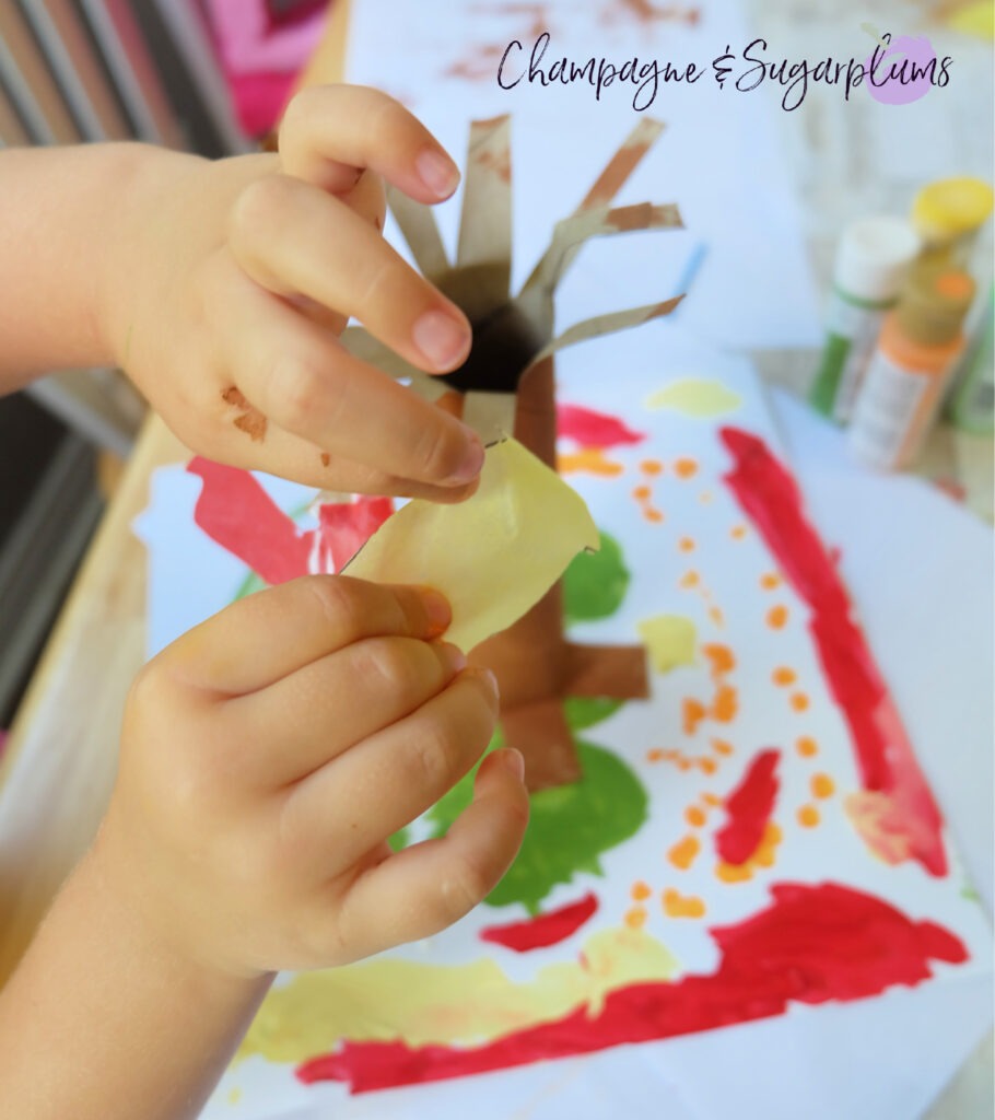 Adding the leaves! Paper Bag Tree Kids Craft for Thanksgiving