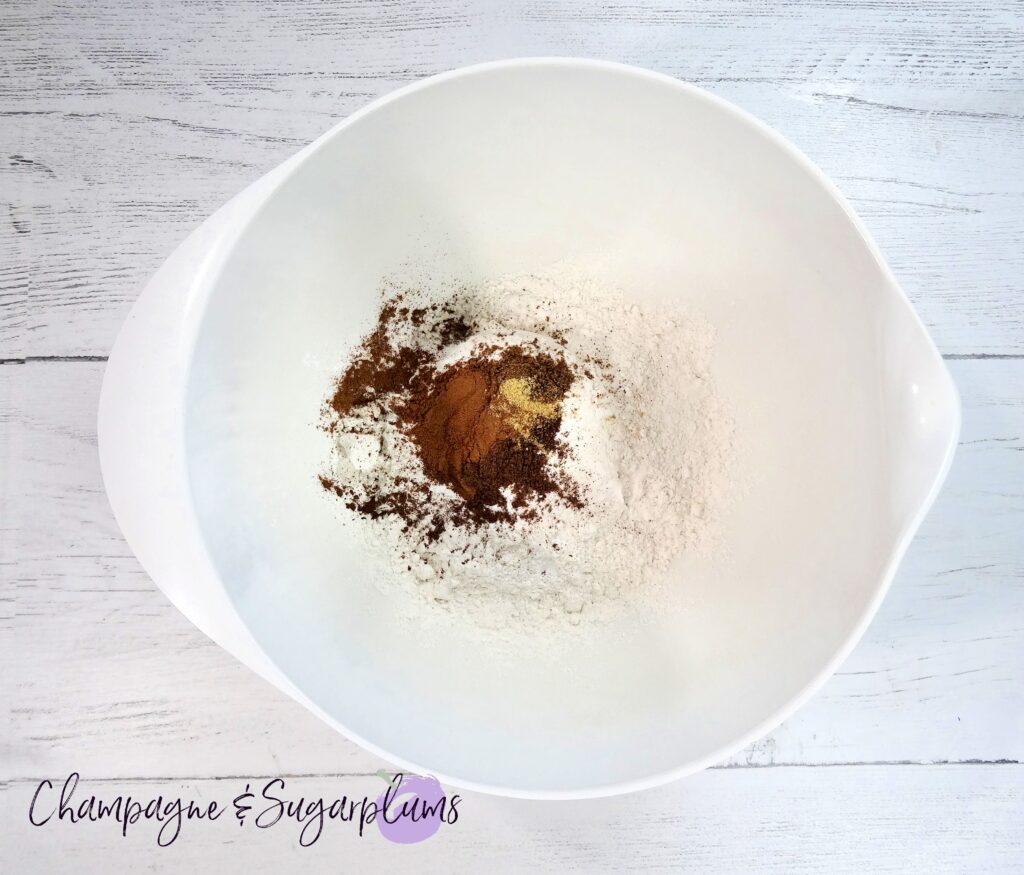 Dry baking ingredients in a white bowl on a white background by Champagne and Sugarplums