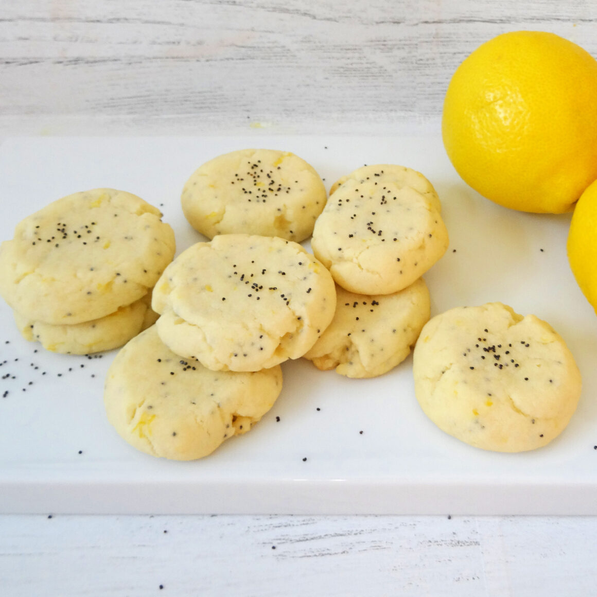 Lemon Poppy Seed Cookies on a white plate by Champagne and Sugarplums