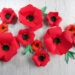 Red paper flowers on a white background by Champagne and Sugarplums