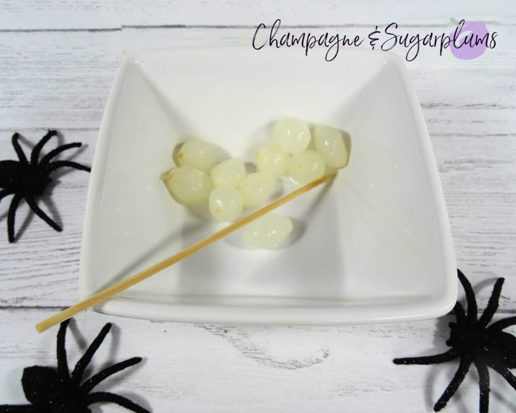 Cocktail onions in a white bowl by Champagne and Sugarplums