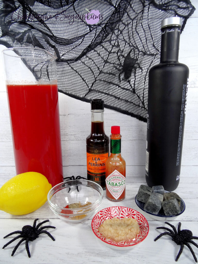 All of the ingredients needed to make a scary Caesar on a white background by Champagne and Sugarplums