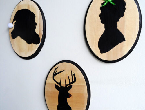 Three oval wood plaques with silhouettes of Santa, Mrs. Claus and Rudolf on a white background by Champagne and Sugarplums