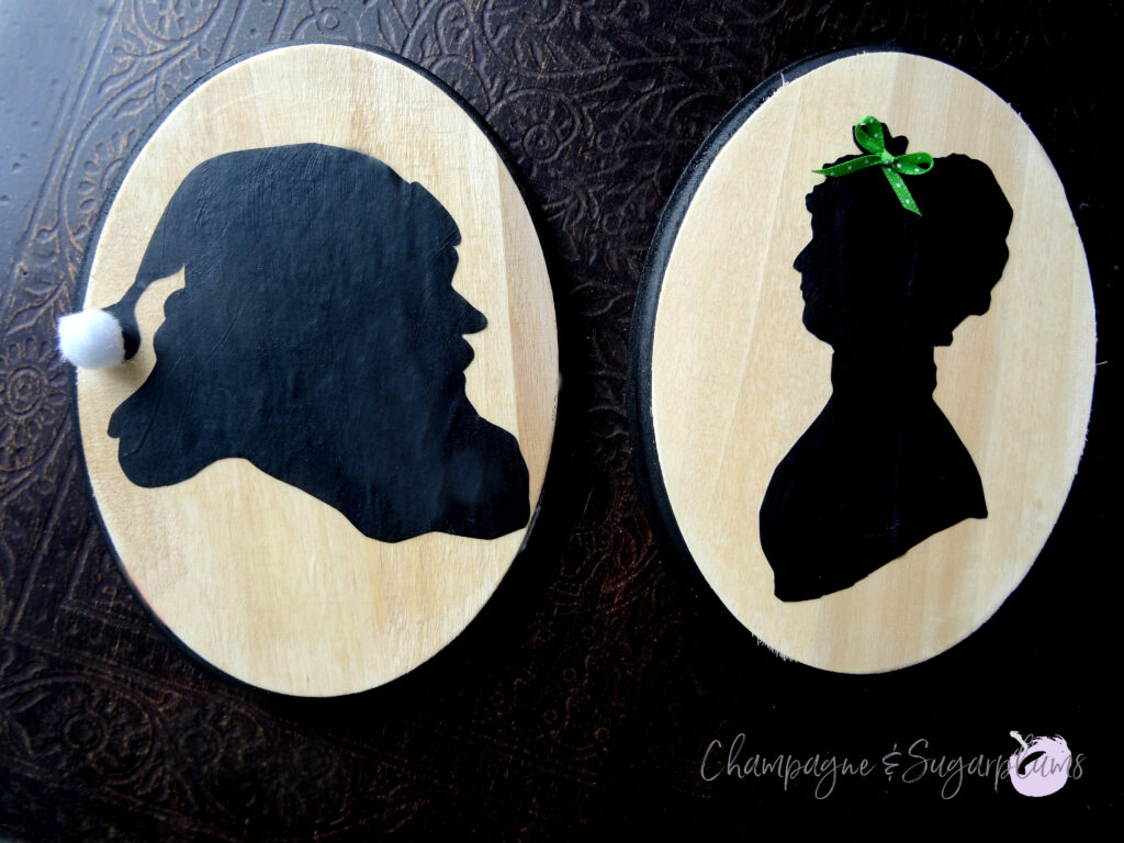 Santa and Mrs. Claus silhouettes on a dark background by Champagne and Sugarplums