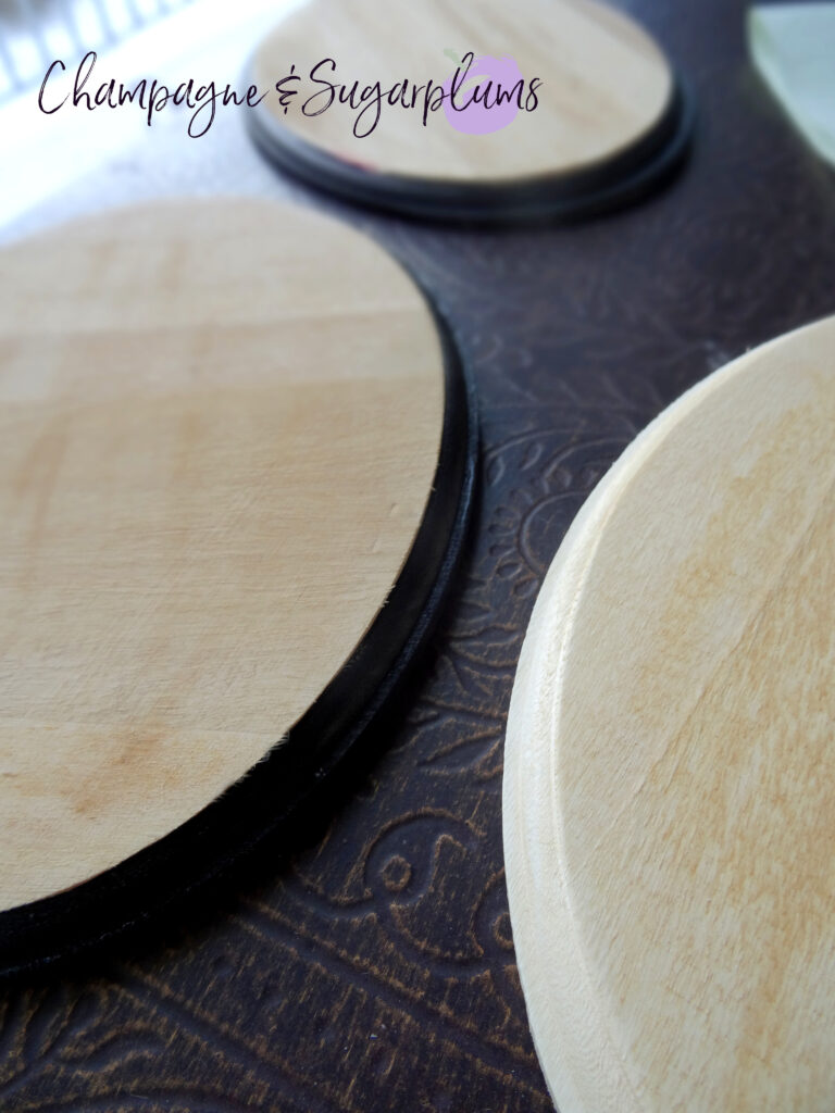 Painting the edges of three oval wood boards black by Champagne and Sugarplums