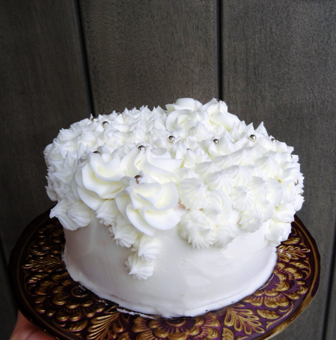 Champagne cake on a cake stand by Champagne and Sugarplums