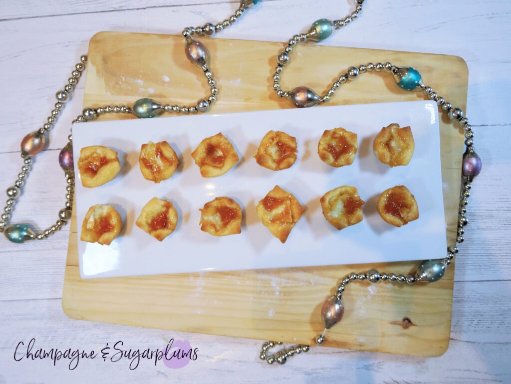 Mango Brie Bites on a white plate with glass garland by Champagne and Sugarplums