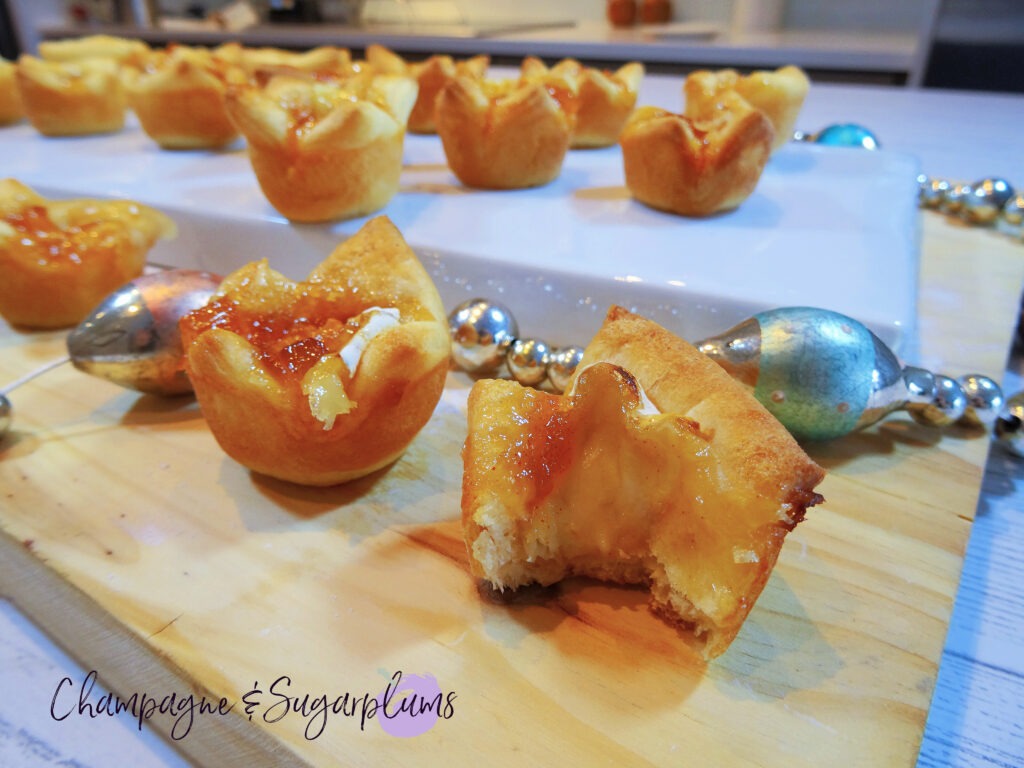 Mango Brie Bites on a white plate with glass garland by Champagne and Sugarplums