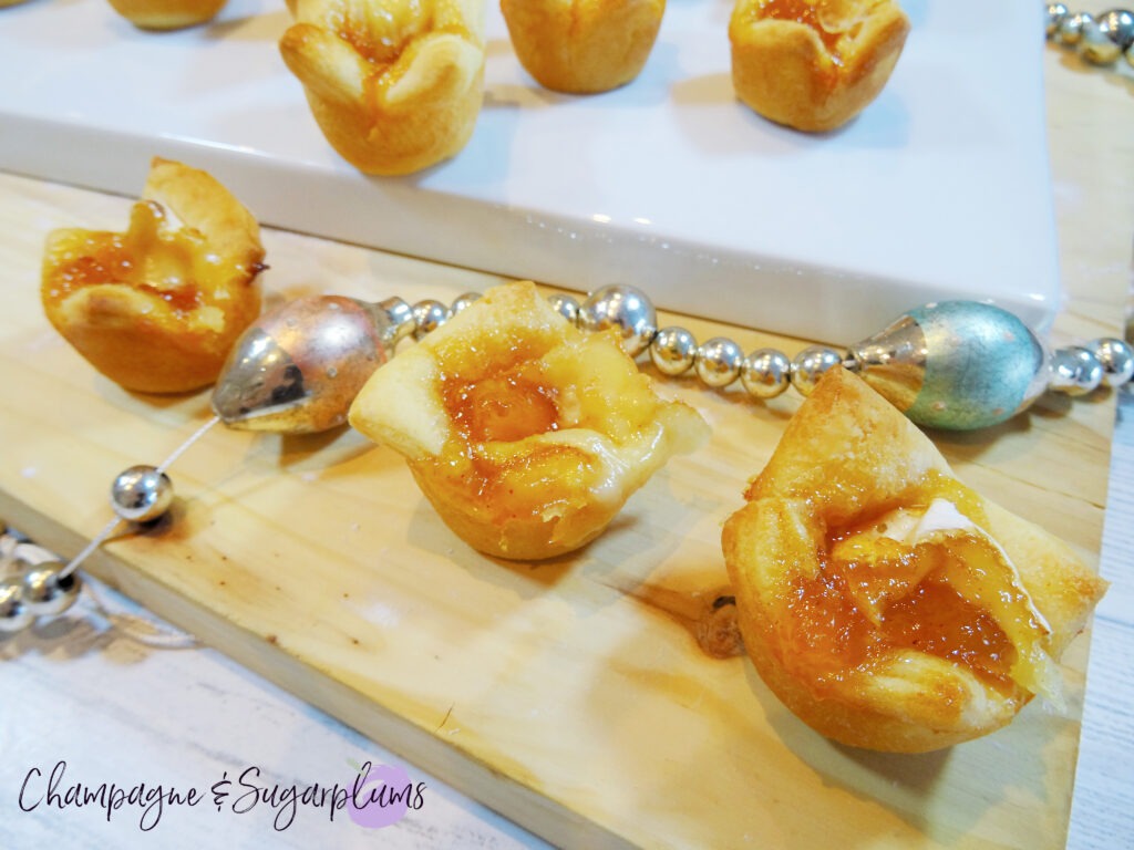 Mango Brie Bites on a white plate with glass garland by Champagne and Sugarplums