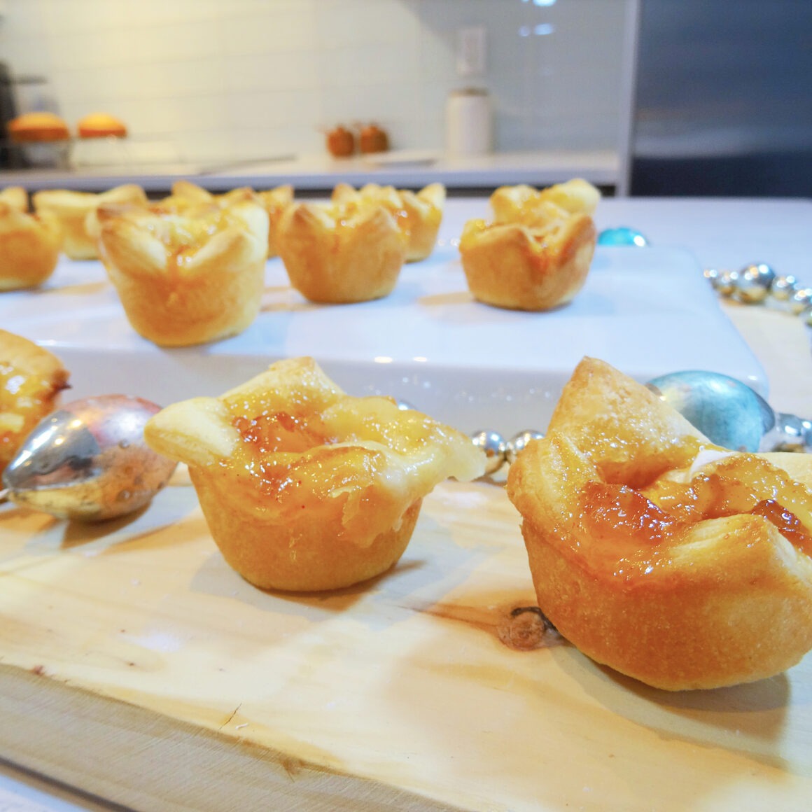 Brie mango bites on a wood tray by Champagne and Sugarplums