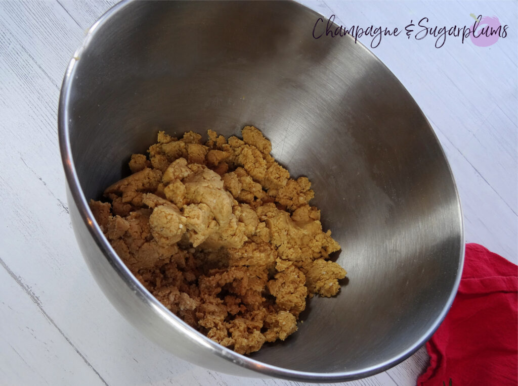 Snowball treat dough in a metal mixing bowl on a white background by Champagne and Sugarplums